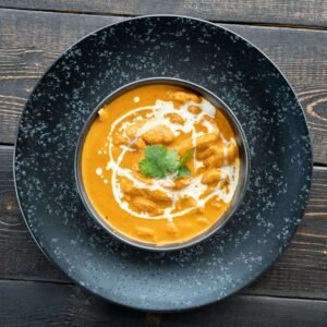 Top view of homemade Shahi Paneer on rustic wooden table, perfect for Indian cuisine lovers.
