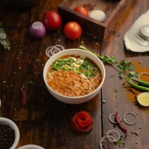 Delicious Indian dal makhani with fresh ingredients on a rustic table setting.