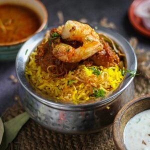 Delicious shrimp biryani with Indian spices, served with traditional condiments in New Delhi, India.